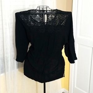 Black blouse with lace trim.